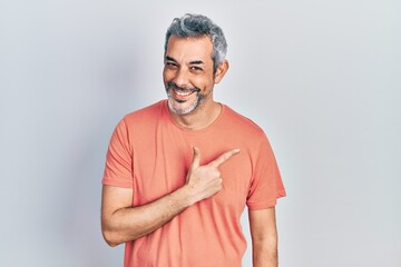 Handsome middle age man with grey hair wearing casual t shirt cheerful with a smile of face...