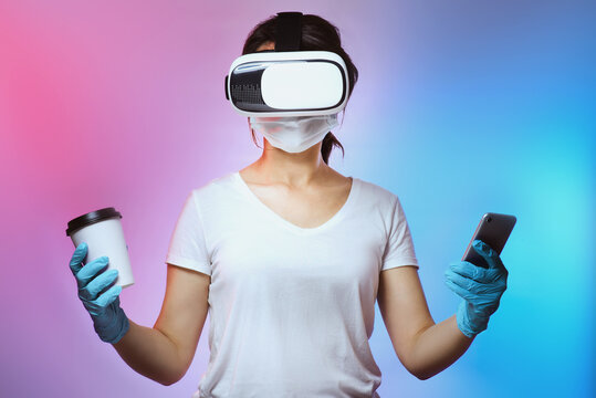 Person of 2021 with a virtual reality glass, a take away coffee cup, a medical face mask and a smart phone.