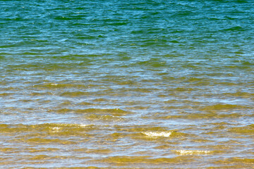 Beautiful marine background. Green sea water smoothly turns into yellow.