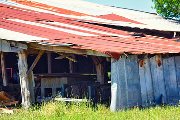 A rusty roof on an old barn on a small rural farm.