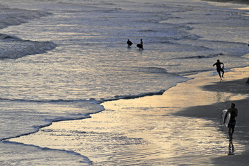 Silhouetted People Play On the Beach at Dusk