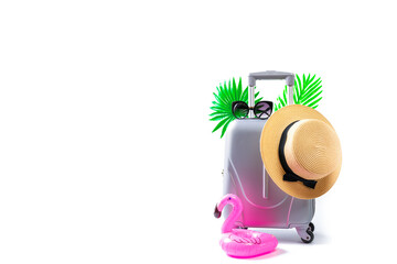 Sea background. Travel accessories with suitcase, straw hat, palm leaves and flamingo in minimal trip vacation concept isolated on white background. Summer vacation and product advertisement concept.
