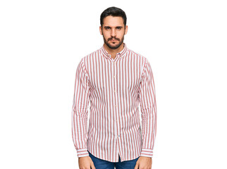 Young hispanic man wearing business shirt skeptic and nervous, frowning upset because of problem....