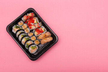 Sushi rolls on pink background, Japanese food