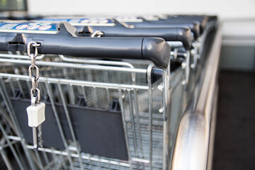 Group of shopping carts in market, empty pushcarts with no groceries 