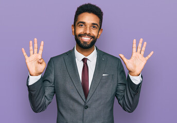 Young african american man wearing business clothes showing and pointing up with fingers number nine while smiling confident and happy.