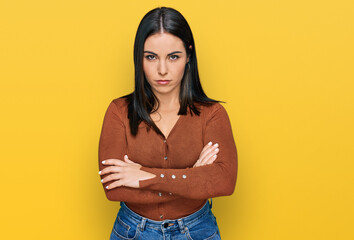 Young hispanic woman wearing casual clothes skeptic and nervous, disapproving expression on face...