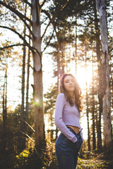 Young, brunette girl walking through the forest