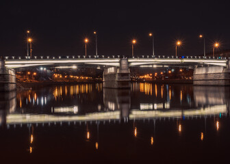 Fototapeta na wymiar Night cityscape with the bridge in lights