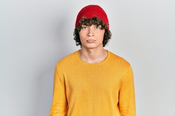 Handsome young man wearing wool hat depressed and worry for distress, crying angry and afraid. sad expression.