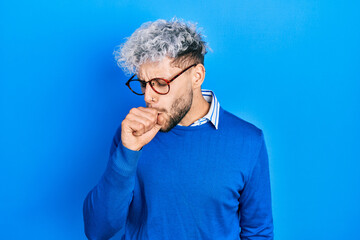 Obraz premium Young hispanic man with modern dyed hair wearing sweater and glasses feeling unwell and coughing as symptom for cold or bronchitis. health care concept.
