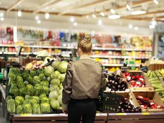 Woman buying fruits and vegetables  at the market