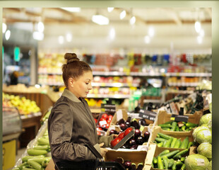 Woman buying fruits and vegetables  at the market