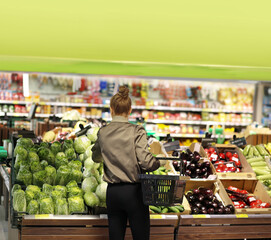 Woman buying fruits and vegetables  at the market