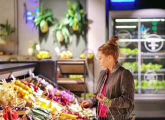 Woman buying fruits and vegetables  at the market