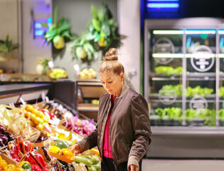 Woman buying fruits and vegetables  at the market