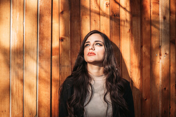 Fototapeta premium Portrait of a beautiful brunette girl smoking, smoking coming out of her mouth