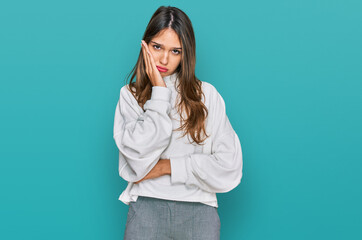 Young brunette woman wearing casual turtleneck sweater thinking looking tired and bored with depression problems with crossed arms.