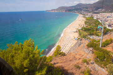 Beach in Alanya, Turkey. View and heights, top view. Blue sea in summer. Vacation in Turkey. Cleopatra beach.