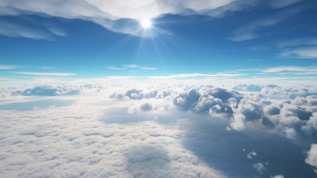 View of the clouds from a plane. The suns shines above