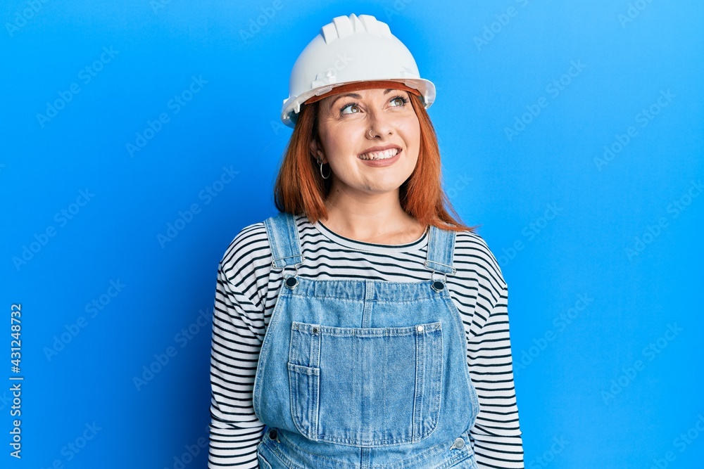 Canvas Prints beautiful redhead woman wearing architect hardhat looking to side, relax profile pose with natural f