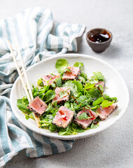 Japanese sliced grilled tuna steak salad with sesame and suace. Close up