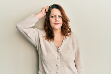 Young caucasian woman wearing casual clothes confuse and wondering about question. uncertain with...