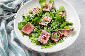 Japanese sliced grilled tuna steak salad with sesame and suace. Close up