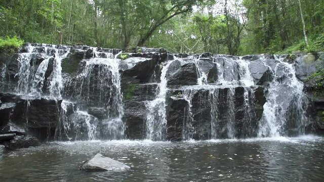 Beautiful waterfall cliff in tropical forest at Namtok Samlan National Park, Saraburi, Thailand - Slow Motion