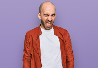 Young hispanic man wearing casual clothes winking looking at the camera with sexy expression, cheerful and happy face.