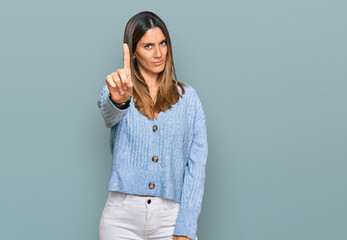 Young woman wearing casual clothes pointing with finger up and angry expression, showing no gesture