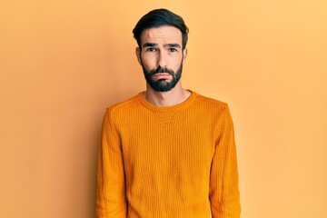 Fototapeta premium Young hispanic man wearing casual clothes depressed and worry for distress, crying angry and afraid. sad expression.