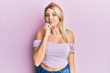 Young caucasian woman wearing casual clothes thinking concentrated about doubt with finger on chin and looking up wondering