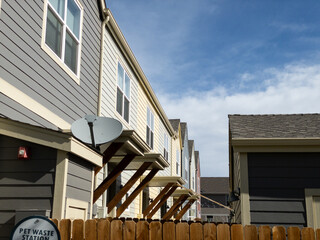 Regular street scene without people in a housing area with multiple units including condo or...