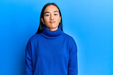 Young asian woman wearing casual winter sweater looking sleepy and tired, exhausted for fatigue and hangover, lazy eyes in the morning.