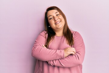 Obraz premium Beautiful brunette plus size woman wearing casual winter sweater happy face smiling with crossed arms looking at the camera. positive person.