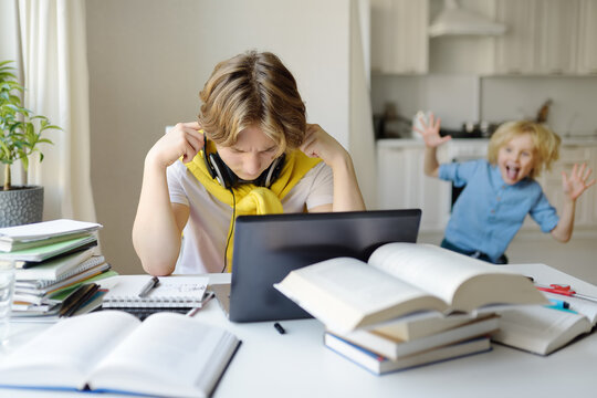 Tennager boy study at home. Online education and distance learning for children. School boy doing his homework using gadgets. Lectures and lessons on the internet for high school students
