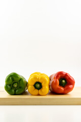 red, yellow and green paprika on cutting board