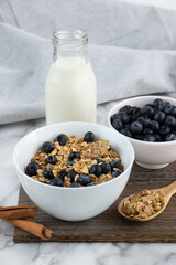 Granola, milk and blueberry plate for breakfast