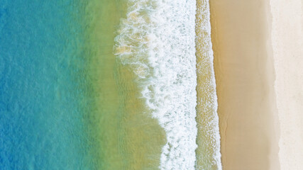 Aerial view of the Gradient color of Ocean surface with waves washing on the coast of the Andaman ocean Amazing top down nature Landscape seascape view beautiful for travel background and website