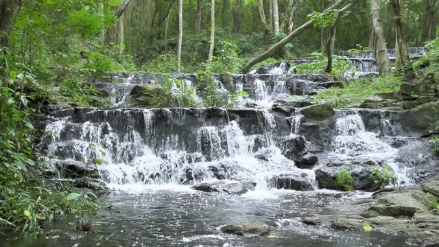 Beautiful stream and waterfall in tropical forest at Namtok Samlan National Park, Saraburi, Thailand - Slow Motion