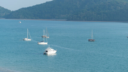 Sailboat or Travel boats in the sea at sunset light with beautiful big mountains background.Luxury summer adventure,active vacation in Andaman sea Phuket Thailand Amazing nature view High angle view