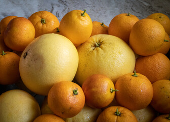 A harvest of yellow grapefruit and blood oranges dries after being washed 