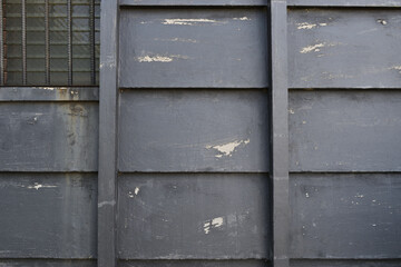 Image of Clapboard-like concrete wall paint peeling
