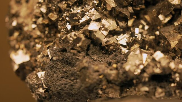 This panning video shows a macro view of a large pyrite nugget.