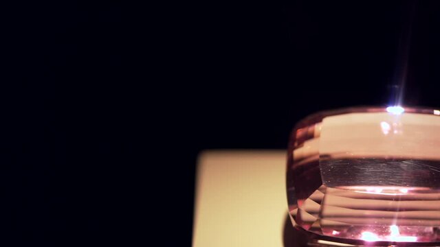 This panning video shows a large stunning pink kunzite gem stone on display.