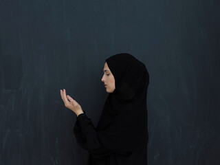 Portrait of young Muslim woman making dua