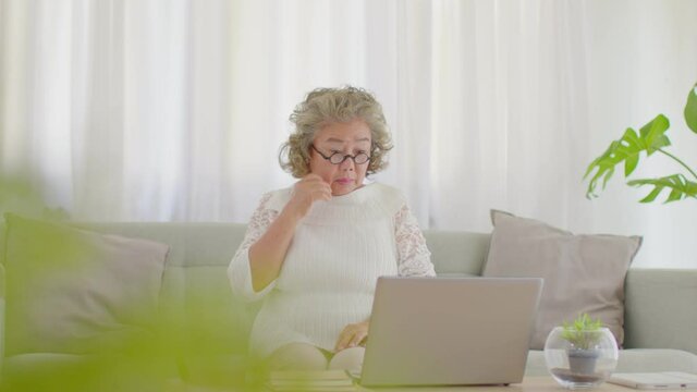 Elderly asian woman with white hairs have a problem with password on computor laptop or human error,Pensioner worry with something wrong and struggling with technology