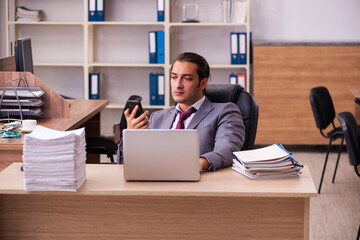 Young male employee extremely tired with excessive work