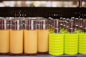 colorful plastic soap dispensers lined up on the store shelf